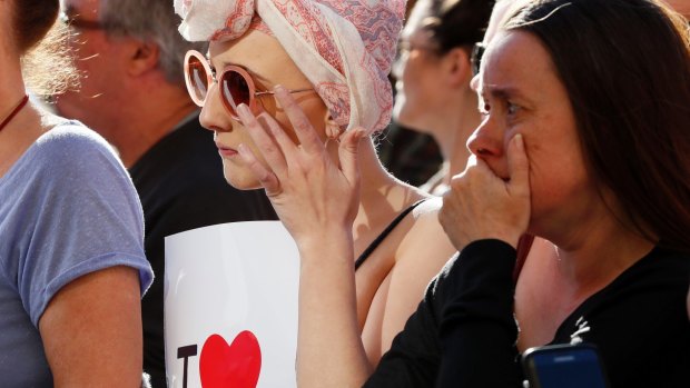 People attend a vigil in Albert Square, Manchester, England.