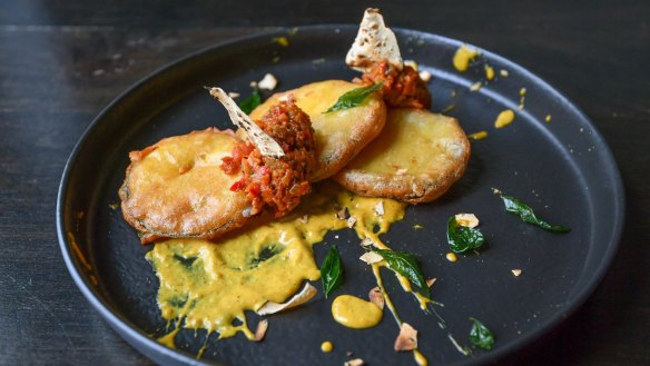 Deconstructed curry: Tempura eggplant with green capsicum and peanuts.