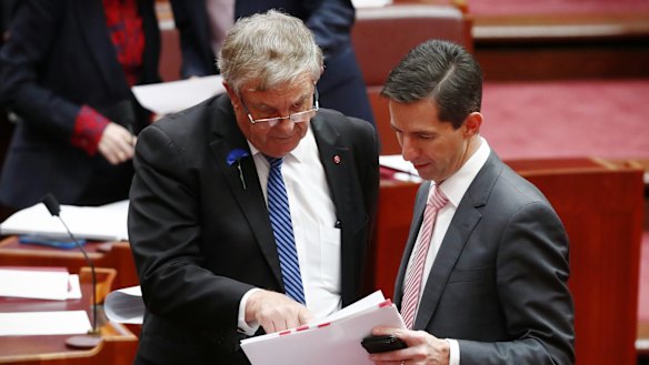 Senator Chris Back and Minister for Education and Training Simon Birmingham during debate on the Australian Education Amendment Bill.