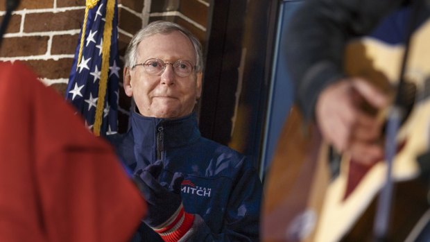 Leading man?: Mitch McConnell, who will become Senate Majority leader if Republicans win and he can hold his own seat, listens to singer Jimmy Rose perform "Coal Keeps the Lights On" at a rally on Saturday.