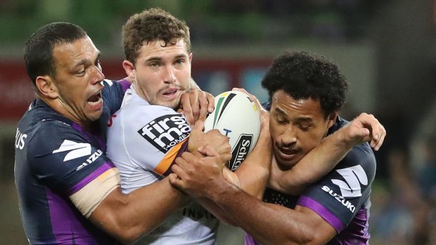 Corey Oates of the Broncos is tackled during the round three NRL match between the Melbourne Storm and the Brisbane Broncos at AAMI Park.