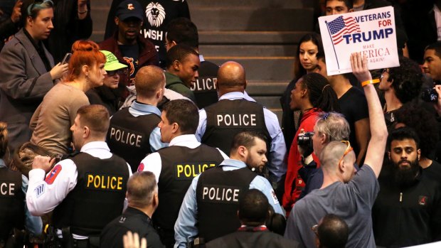 A demonstrator is removed by Chicago police during a rally for Republican presidential candidate Donald Trump on Friday.