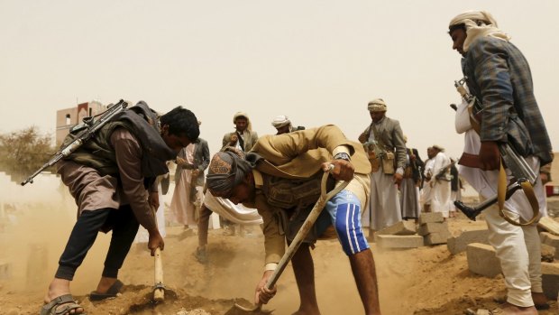 Ready for peace talks: Houthi fighters bury a comrade.