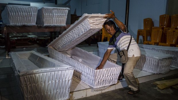 A man prepares coffins ahead of the executions of Bali nine pair Andrew Chan and Myuran Sukumaran.