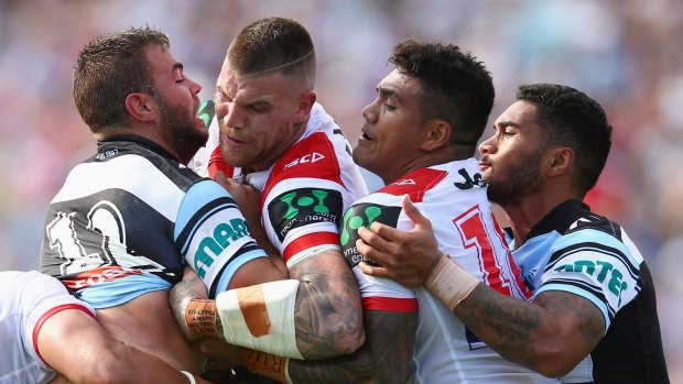 Wrapped up: Josh Dugan is crunched by Wade Graham.