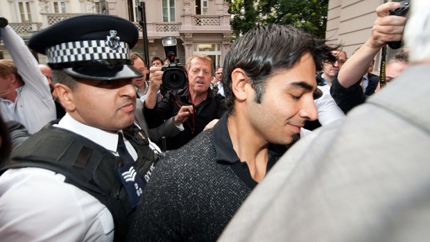 Caught: Pakistani cricketer Salman Butt is escorted by police through a media scrum in London in 2010.