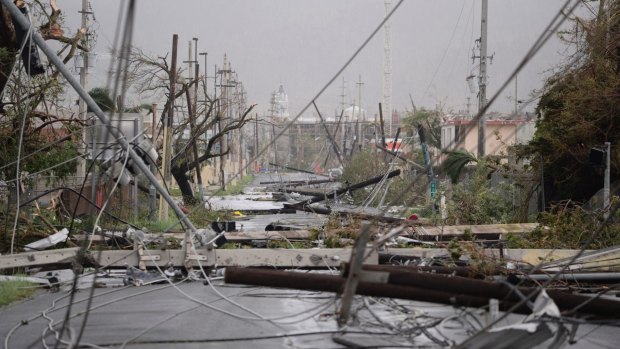 Electricity poles and lines lay toppled on the road after Hurricane Maria hits  Puerto Rico.