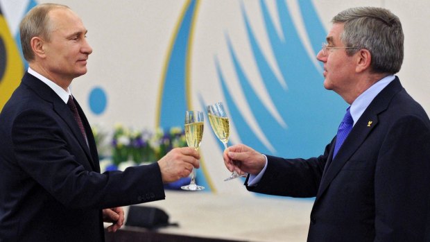 Russian President Vladimir Putin, left, toasts a glass of champagne with Thomas Bach in 2014.