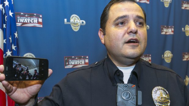 Continuous record: Los Angeles Police Sergeant Dan Gomez demonstrates a video feed from his on-body camera into his mobile phone during a news conference in Los Angeles.