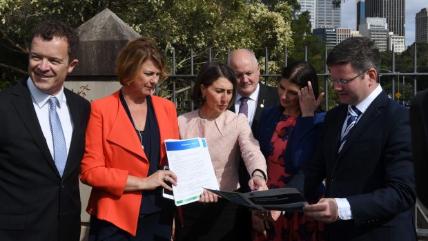 Premier Gladys Berejiklian and Roads Minister Melinda Pavey, second from left, have committed to the first three stages of the F6 extension. 