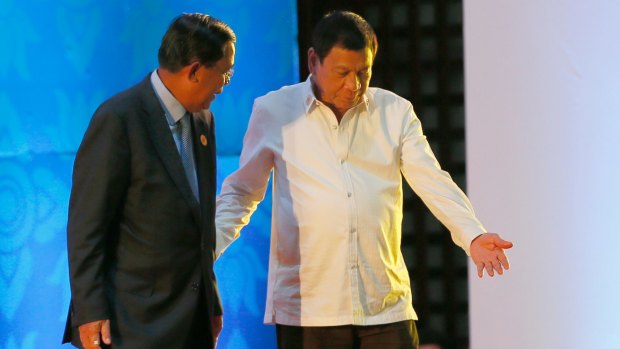 Two strongmen: Philippine President Rodrigo Duterte, right, ushers Cambodian Prime Minister Hun Sen in Vientiane, Laos.
