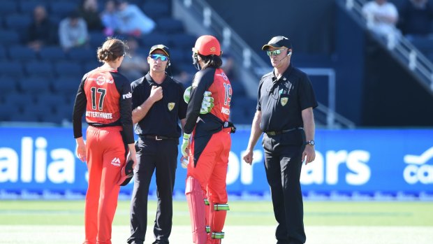 Renegades players Amy Satterthwaite and Emma Inglis question the umpires on Wednesday.