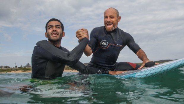Blind surfer Derek Rabelo and former world champ Tom Carroll are stoked after surfing together at North Palm Beach. 