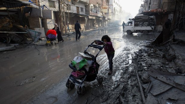 Years of civil war have destroyed normal life for the people of Syria. Here, a child makes her way past the remnants of destroyed buildings in Damascus. 