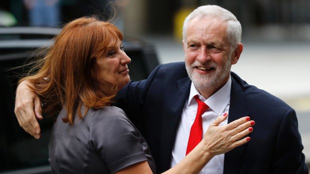 Britain's Labour party leader Jeremy Corbyn is greeted as he arrives at Labour party headquarters.