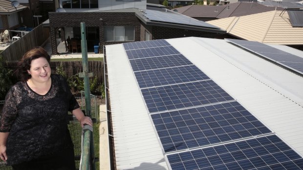 Rachael Turner of Forde with her 5.2kW solar power system that has a battery storage system, taking part in a battery trial launched by  ActewAGL and Panasonic.