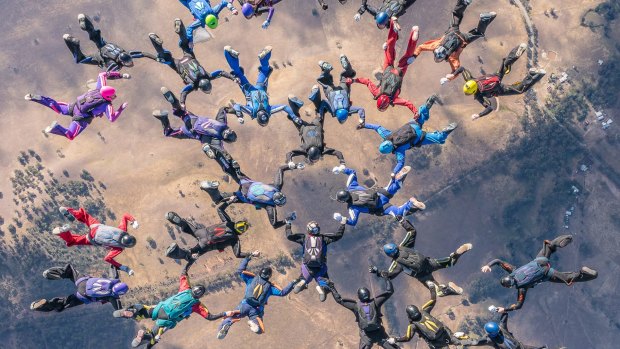A group of skydivers came together to claim a new national record on Friday. 