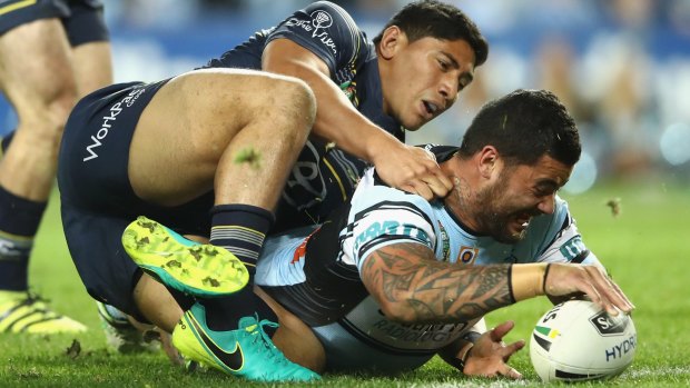 Heavyweight clash: Jason Taumalolo of the Cowboys tackles Andrew Fifita of the Sharks as he scores a try, only to have it disallowed for a double movement during their September 2016 clash. 
