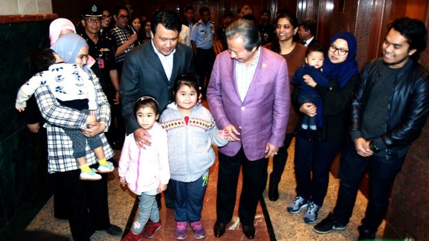 Malaysian Foreign Minister Anifah Aman, third right, walks next to the nine Malaysians just arrived from Pyongyang on Friday.