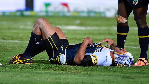 Laid low: Jonathan Thurston recovers from the horror tackle.