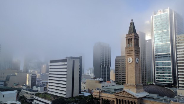 A heavy fog cover shrouds the Brisbane CBD on Monday morning.