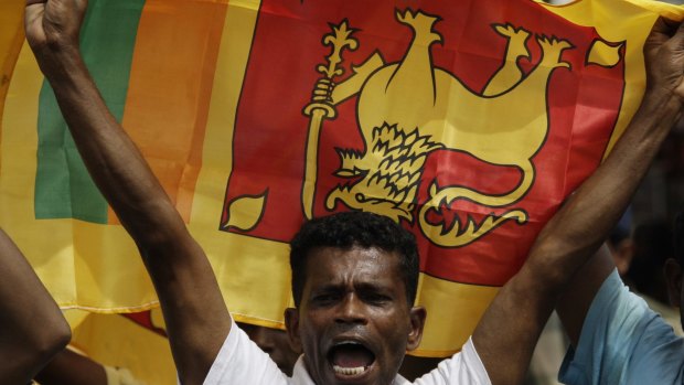 A Sri Lankan man waves his national flag as he celebrates the impending defeat of the Tamil Tiger rebels in 2009.