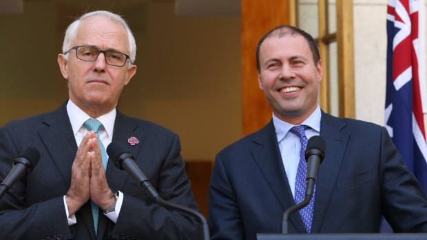 Let there be light: Prime Minister Malcolm Turnbull shows Energy and Environment Minister Josh Frydenberg how to pray.