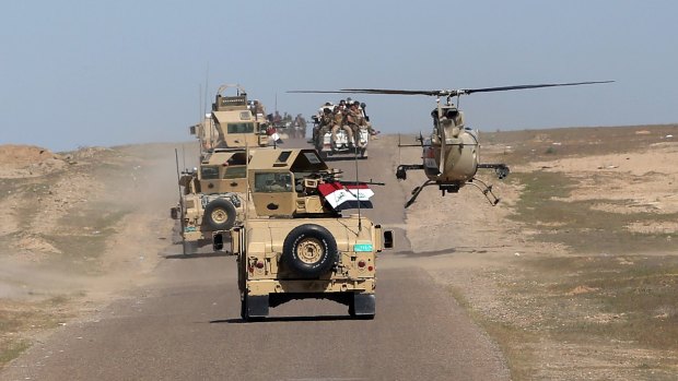 Iraqi Defence Minister Khaled al-Obeidi's convoy tours the front line in the Samarra desert, Iraq, earlier this month.