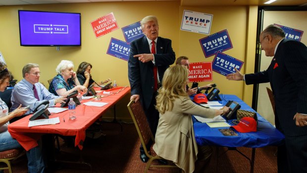 Donald Trump (centre) and Rudy Giuliani (right) in one of Trump's campaign rooms.