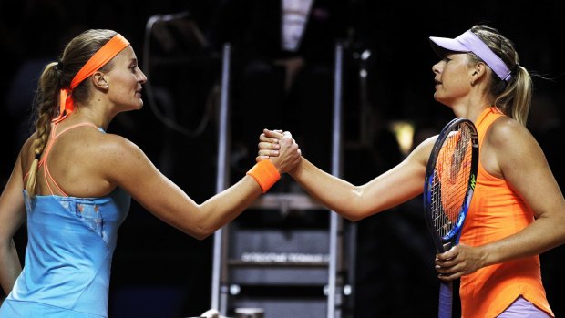 Maria Sharapova shakes hands with Kristina Mladenovic.