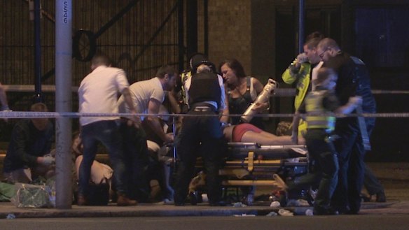People receive medical attention in Thrale Street near London Bridge.
