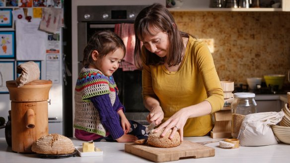 Nerida Thompson with daughter Florence eating their homemade bread.