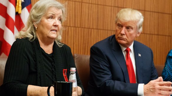 Republican presidential candidate Donald Trump looks on as Juanita Broaddrick, who has accused former President Bill Clinton of sexual assault, speaks.