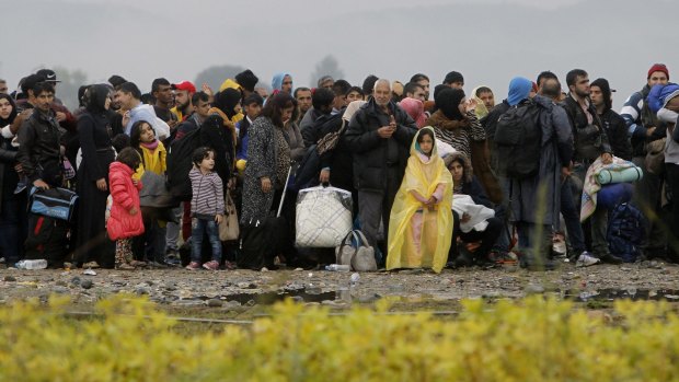 People wait to enter a transit camp for refugees near the southern Macedonian town of Gevgelija on Thursday.