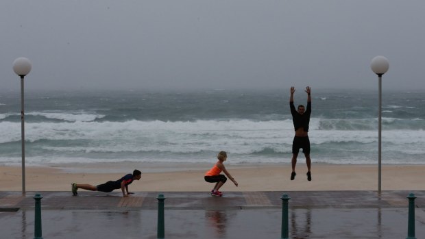 Adidas training ambassador Christian Miranda gets runners to stretch at Bondi Beach.