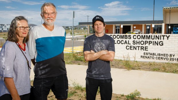 Coombs residents Alison and John Hutchison, and Damian Breach say they have not been able to get any answers from the ACT Government about when the privately-developed Coombs shops will be open for business.