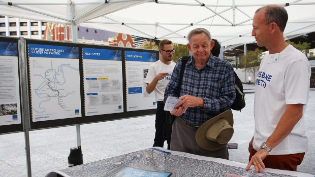 Members of the Brisbane Metro project team present maps and information to the public at King George Square on Saturday.