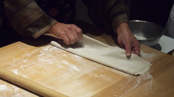 To get long, even noodles, fold the dough over and over onto itself.