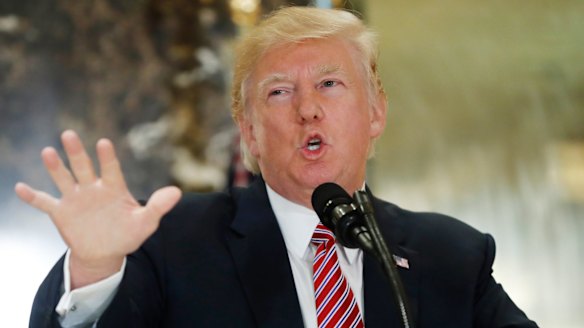 President Donald Trump speaks to the media in the lobby of Trump Tower in New York.