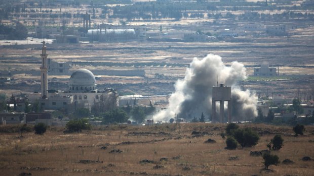 A picture taken from Golan Heights shows smoke rising following explosions in a village in Syria's Quneitra province.