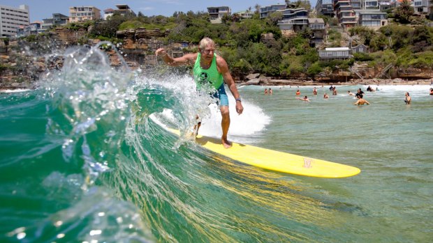 Australia's first surfing world champion, Midget Farrelly shows his style at Freshwater Beach as part of a celebration to mark 100 years of surfing.