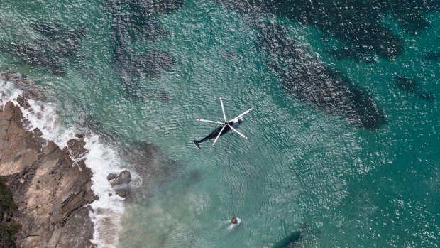 A water-bombing helicopter returns to the ocean near Lorne for a refill.