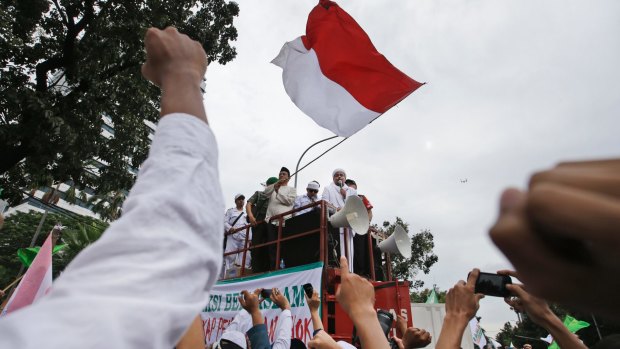 Muslim protesters raise their fists as the leader of Islamic Defenders Front, Rizieq Shihab, gives a speech during a protest against Jakarta's ethic Chinese and Christian governor Basuki Tjahaja Purnama.