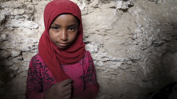 An internally displaced girl stands in a cave in Amran province on Saturday.