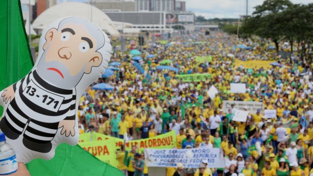 An inflatable figure in the likeness of Luiz Inacio Lula Da Silva, former president of Brazil, is seen as demonstrators gather during a protest against Dilma Rousseff in Brasilia in March.
