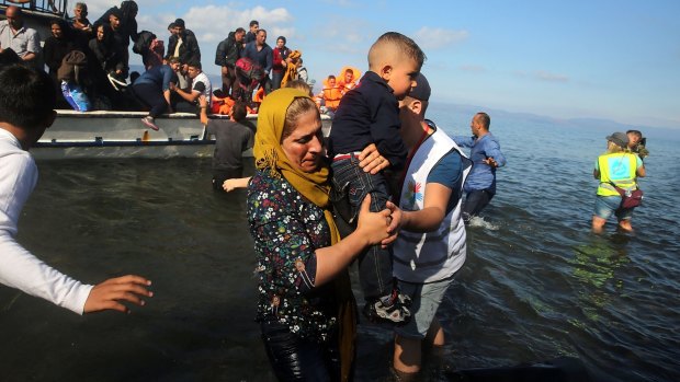 Syrian and Iraqi refugees arrive on boats in Lesbos, Greece, from Turkey.