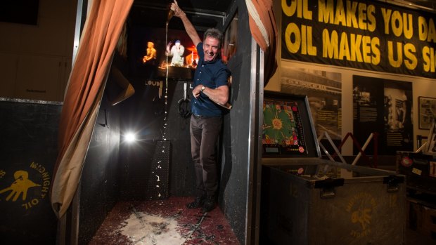 Midnight Oil's Rob Hirst helps create the authentically sticky carpet at The Making of Midnight Oil exhibition. 