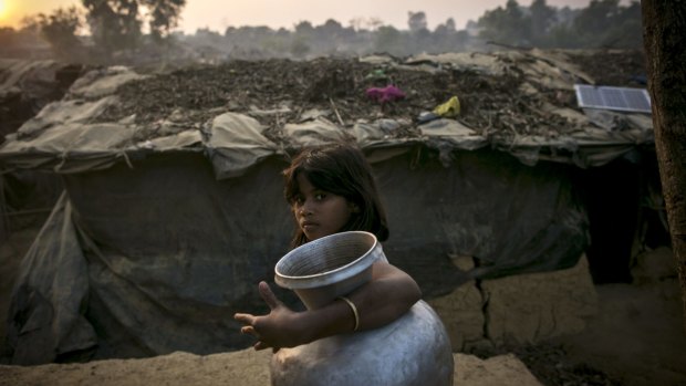 A girl carries a water jug in a Rohingya refugee camp in Cox's Bazar, Bangladesh. 