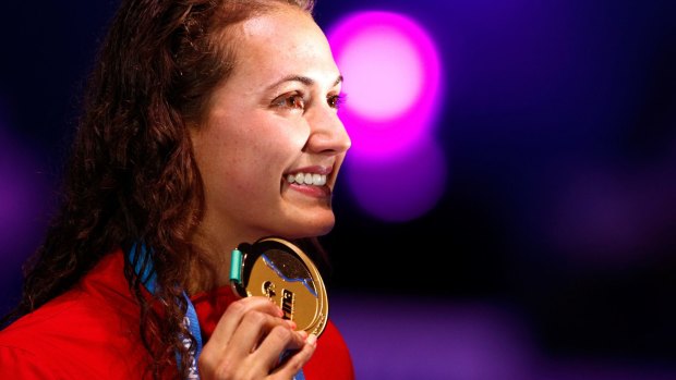 World-record holder: Kylie Masse of Canada poses with the gold meda.
