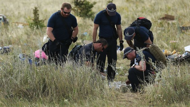 Australian Federal Police officers and their Dutch coutnerparts collect human remains from the MH17 crash site in the fields outside the village of Grabovka in the self proclaimed Donetsk Republic, Ukraine. 
